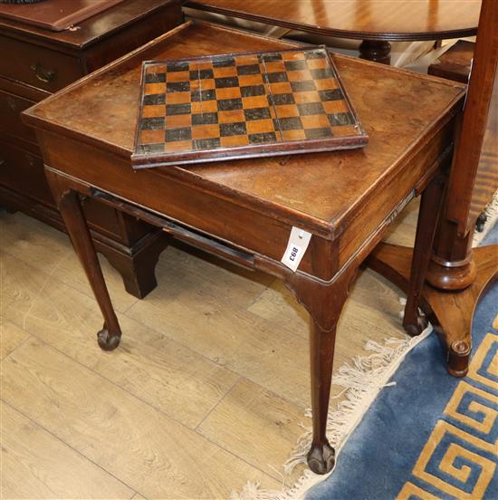 A George II mahogany backgammon table having reversible baize-lined top with counter wells and pull-out W.73cm